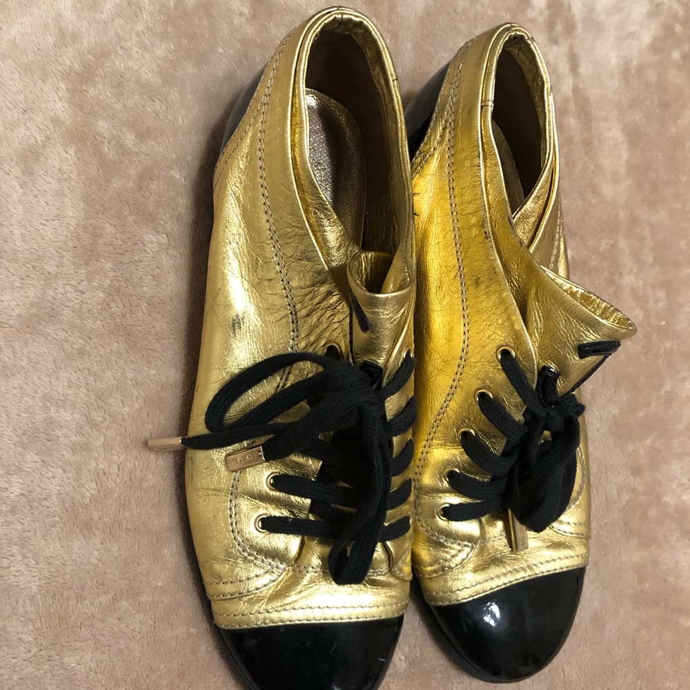 CHANEL gold and black leather sneakers